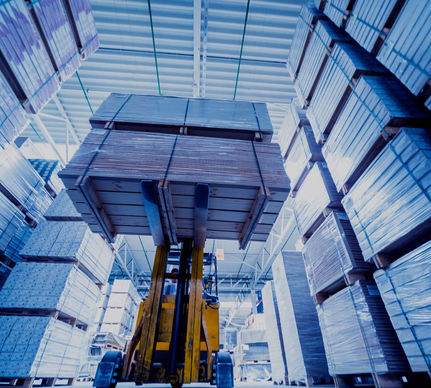 Forklift stacking pallets in a warehouse
