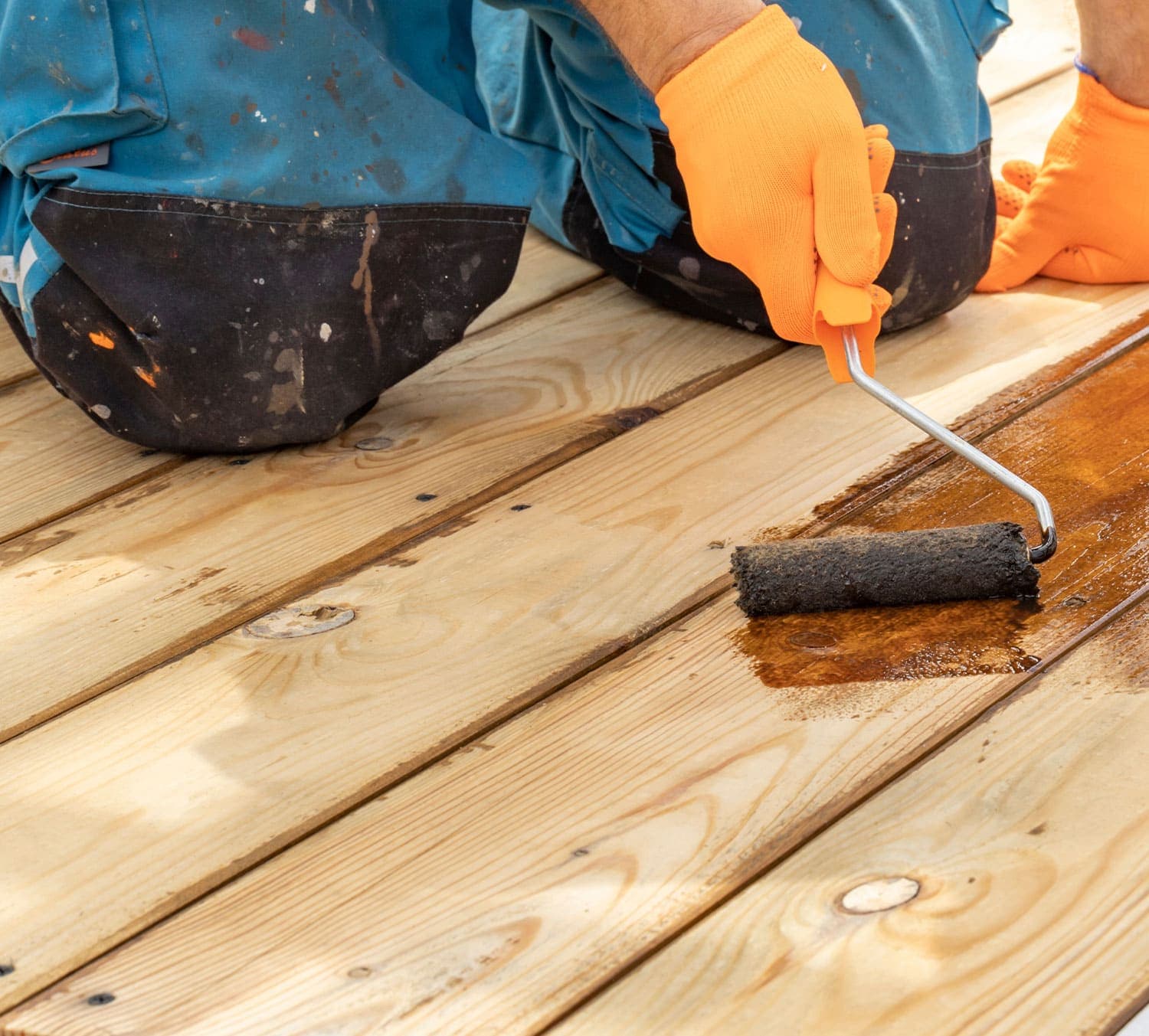 Sealing a timber deck with a roller