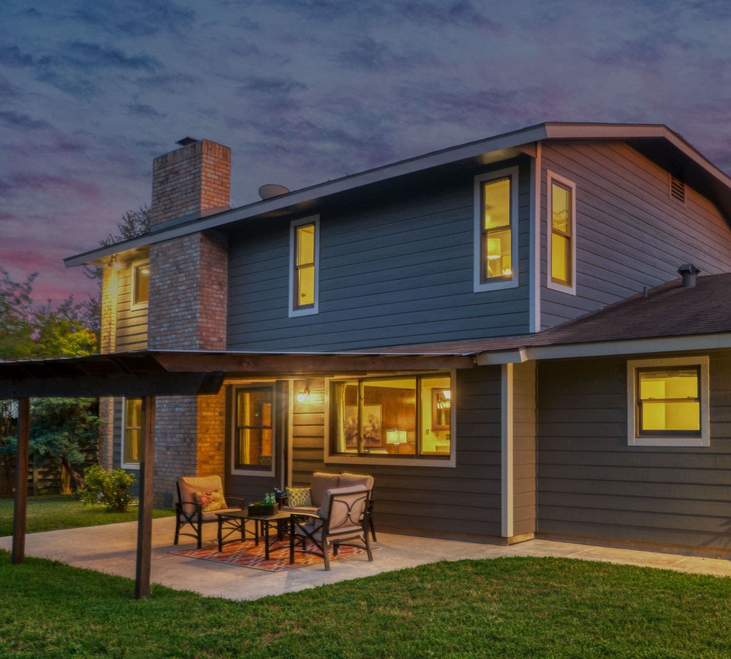 Recladded home at dusk with warm lighting