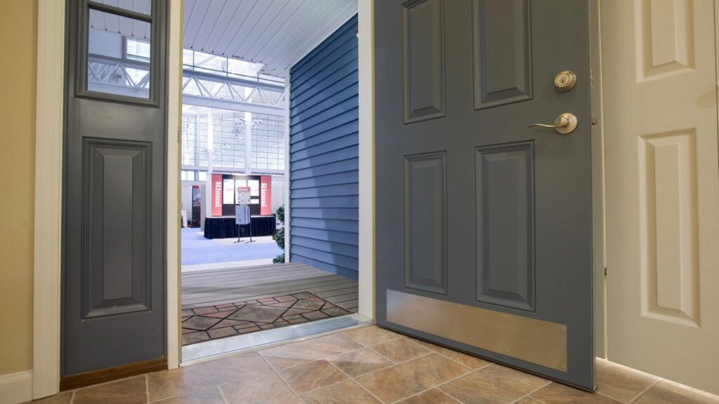 Wide, level-access entry doorway with a protective kick plate